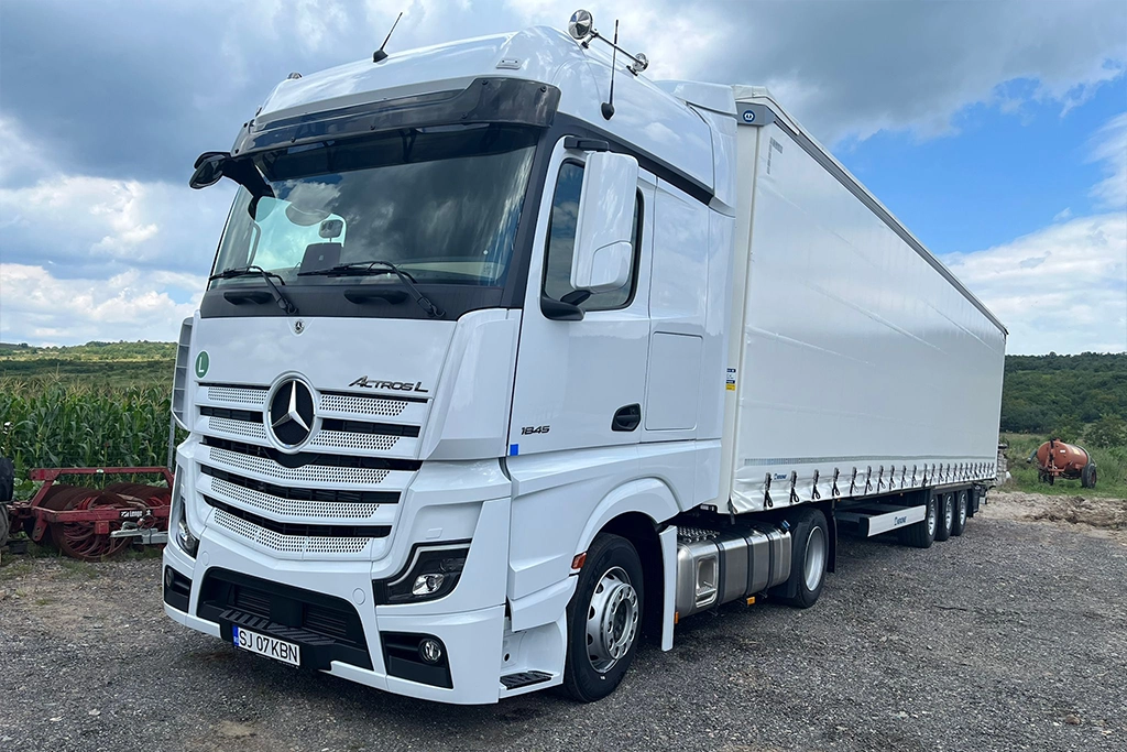 Camion Mercedes-Benz si semiremorca cu prelata din flota de transport international